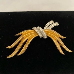 Vintage gold tone swag shaped brooch with clear rhinestones
